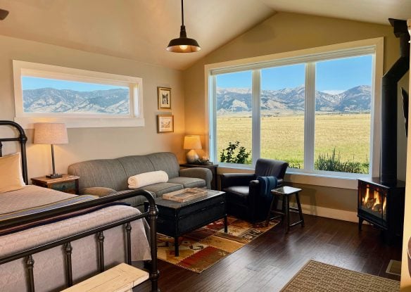 Living room of a cabin with a gas stove and mountain view