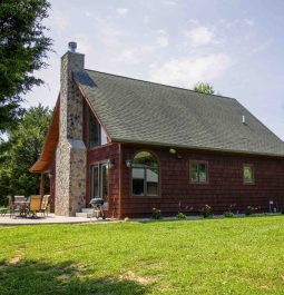 cabin with chimney next to the lake