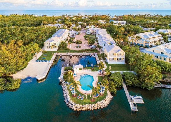 aerial view of islander resort with pool surrounded by water