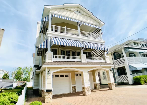 Multi-story beach house exterior with garage underneath